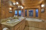 Master Bathroom with a large jetted tub with windows to look at the view